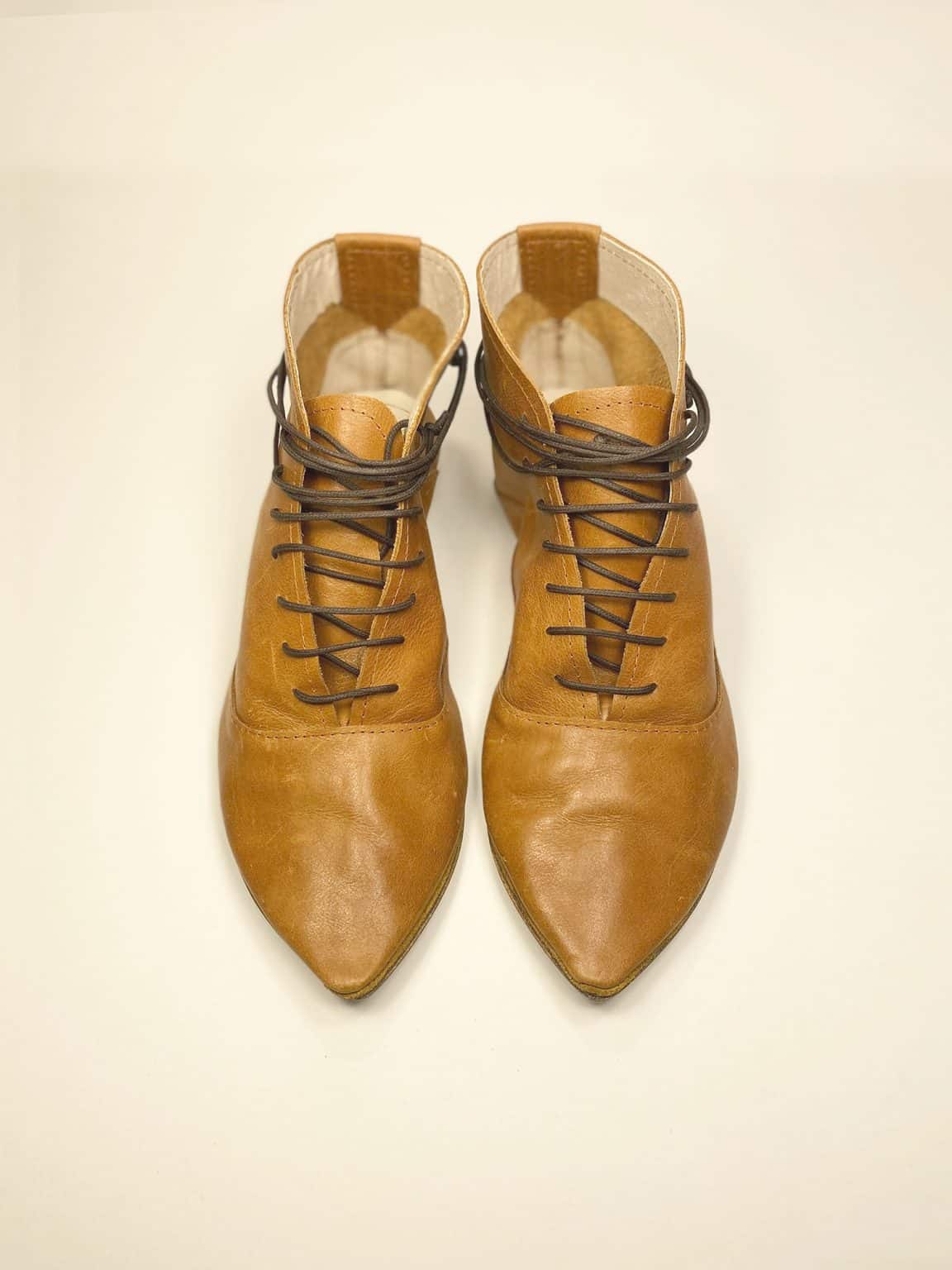 Women's camel tan leather ankle boots with pointed toe and lace-up design, handcrafted in Italy