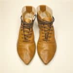 Women's camel tan leather ankle boots with pointed toe and lace-up design, handcrafted in Italy
