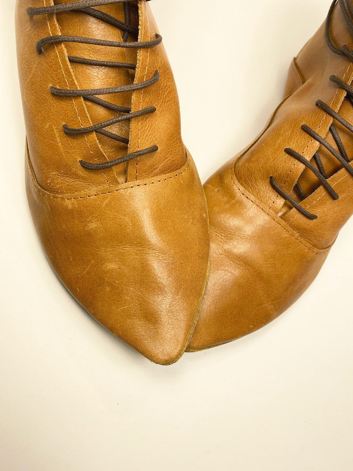 Women's camel tan leather ankle boots with pointed toe and lace-up design, handcrafted in Italy