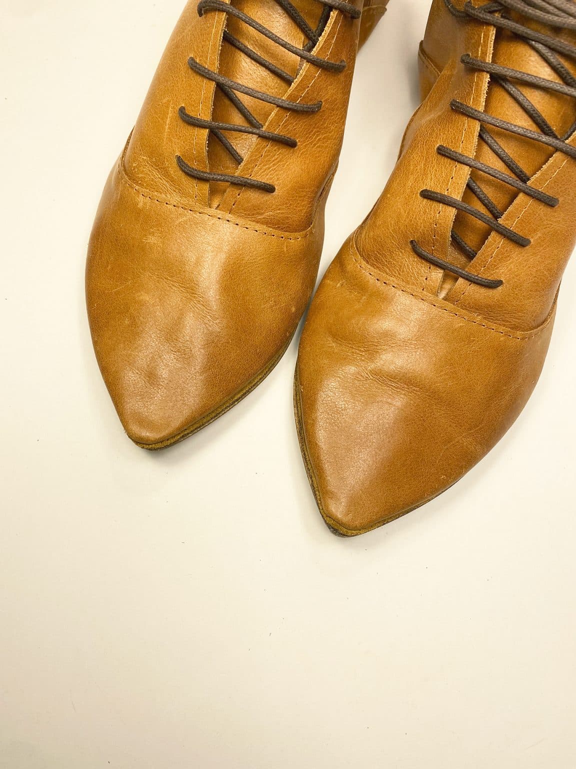 Women's camel tan leather ankle boots with pointed toe and lace-up design, handcrafted in Italy