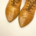 Women's camel tan leather ankle boots with pointed toe and lace-up design, handcrafted in Italy