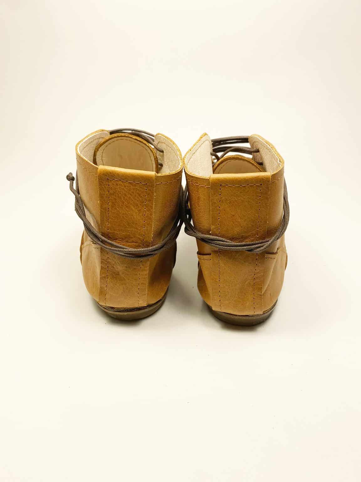 Women's camel tan leather ankle boots with pointed toe and lace-up design, handcrafted in Italy