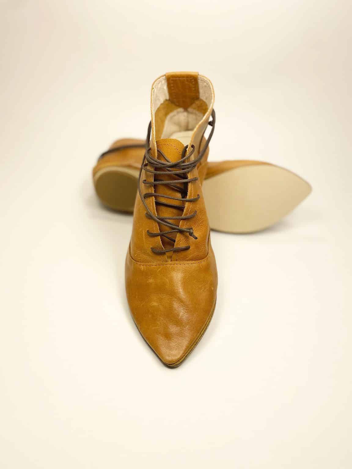 Women's camel tan leather ankle boots with pointed toe and lace-up design, handcrafted in Italy