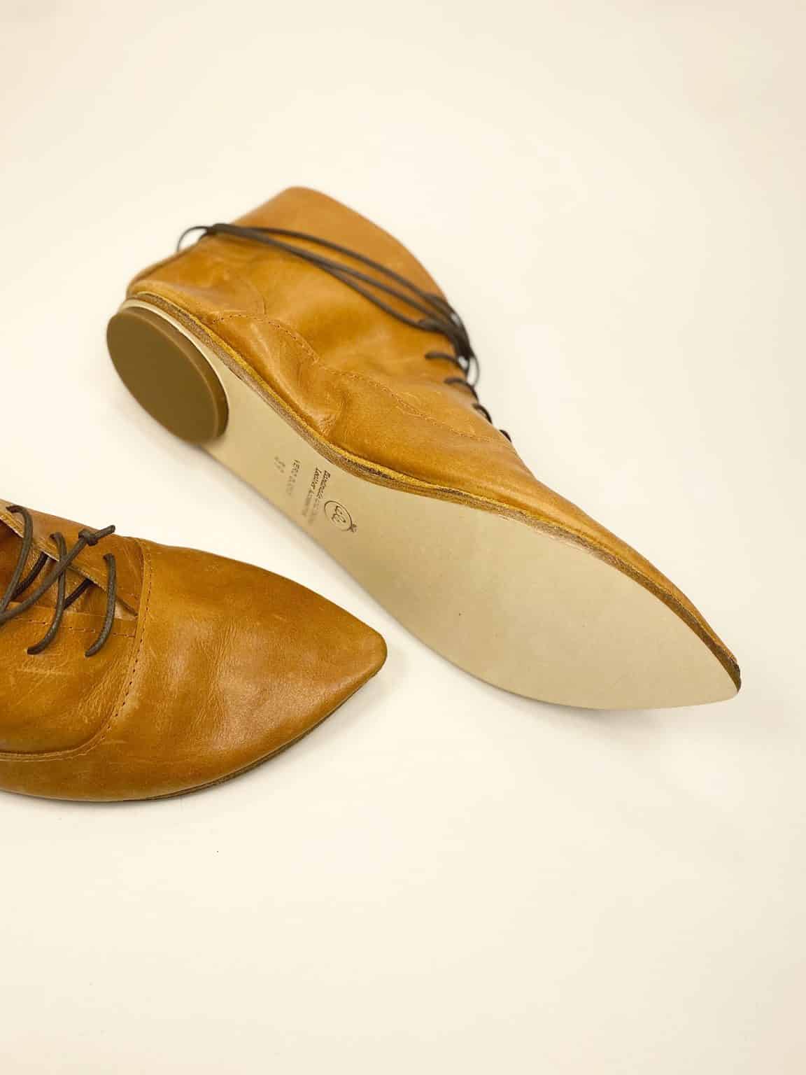Women's camel tan leather ankle boots with pointed toe and lace-up design, handcrafted in Italy