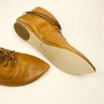Women's camel tan leather ankle boots with pointed toe and lace-up design, handcrafted in Italy