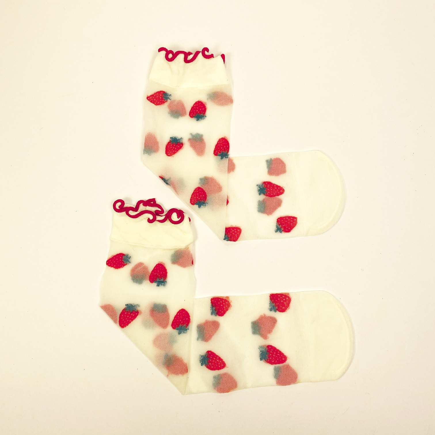 Sheer transparent socks with embroidered strawberries and red ruffled cuff