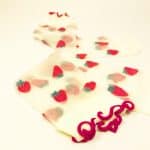 Sheer transparent socks with embroidered strawberries and red ruffled cuff