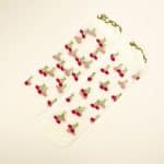 Sheer socks with red cherry embroidery and green stems on transparent mesh