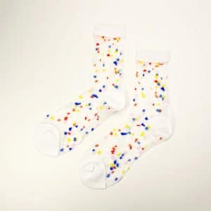 Sheer white socks with multicolored dots and white toe and cuff on a white background