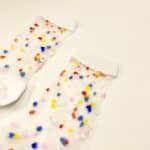 Close-up of colorful confetti details on sheer socks with white cuff