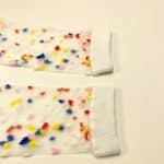 Close-up of colorful confetti details on sheer socks with white cuff