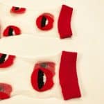 Detailed view of red lips pattern on sheer socks with red cuff