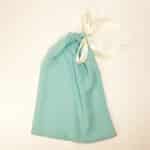 Soft mint cotton dust bag for shoes tied with ivory satin ribbon