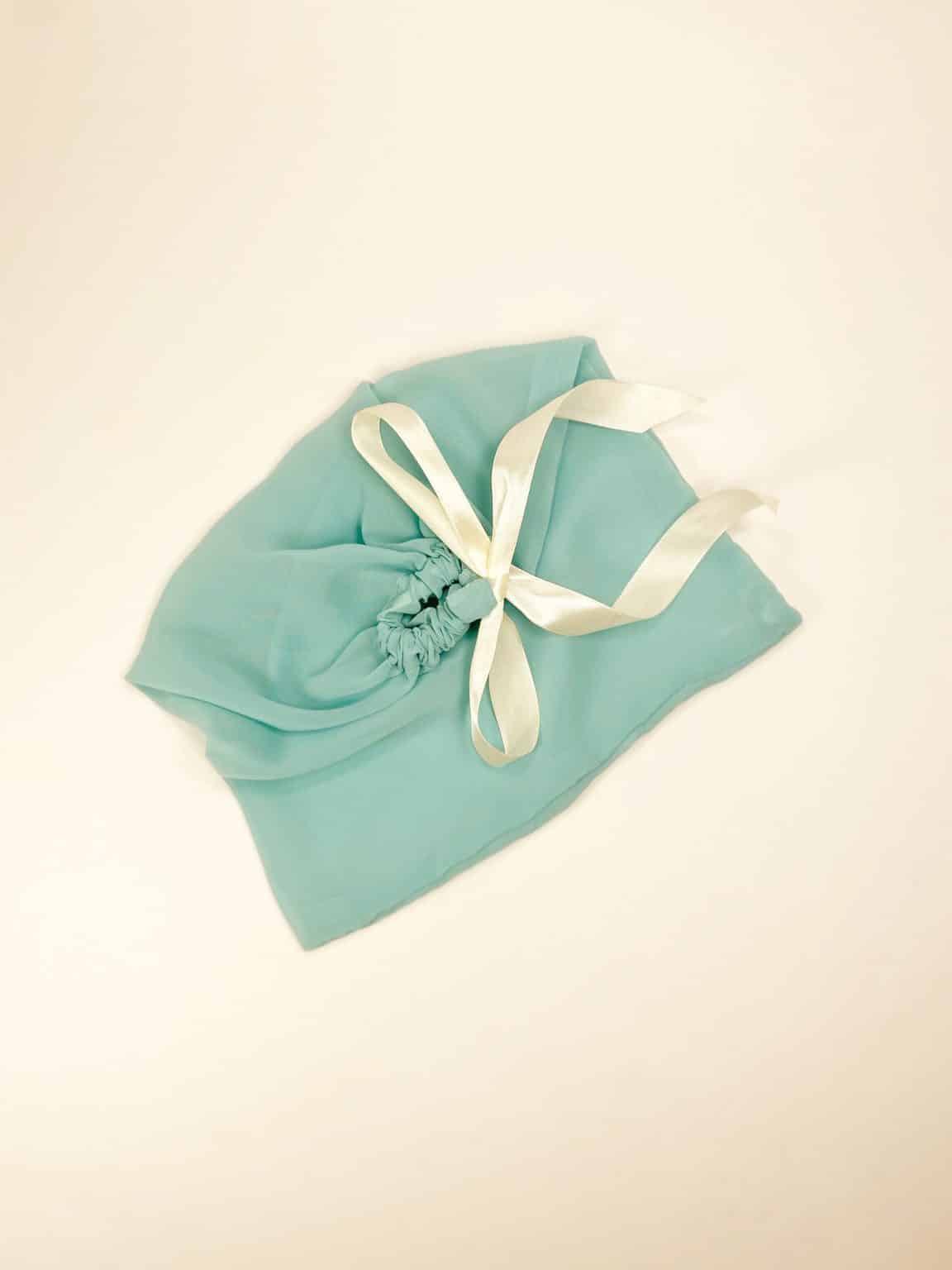 Soft mint cotton dust bag for shoes tied with ivory satin ribbon