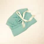 Soft mint cotton dust bag for shoes tied with ivory satin ribbon