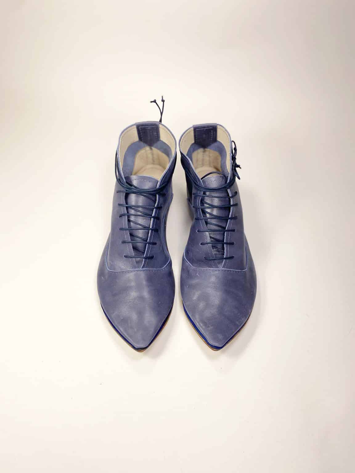 Top-down view of blue leather pointed-toe lace-up shoes, Italian handmade design