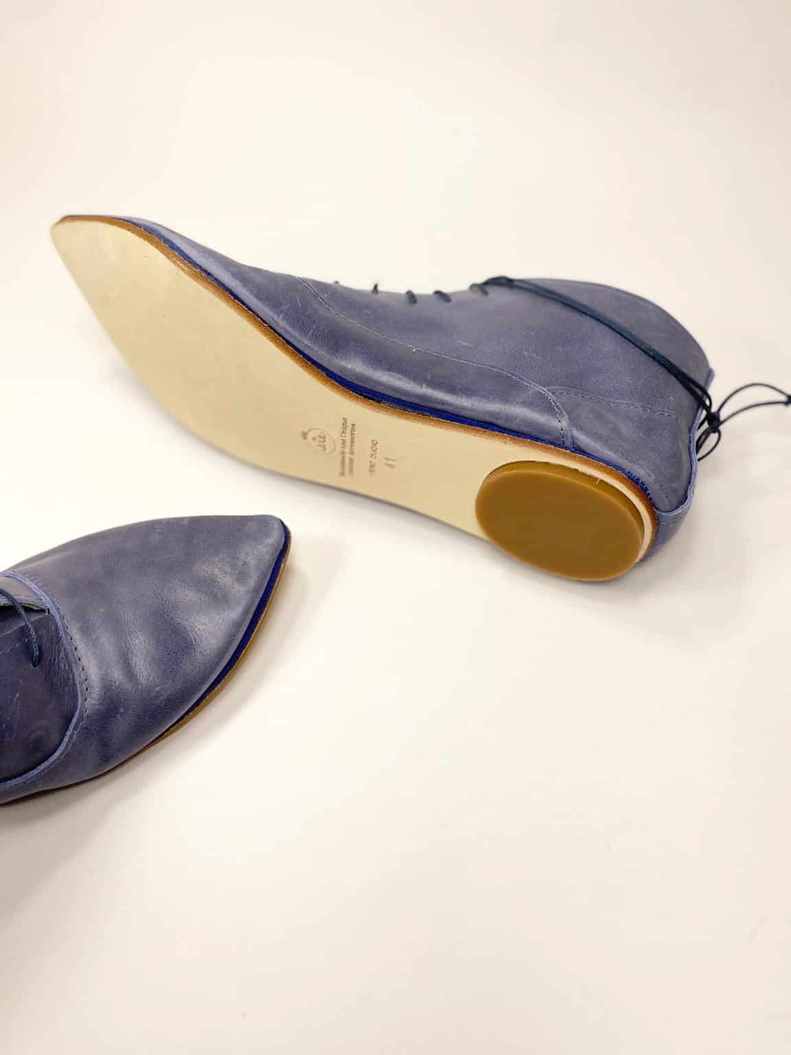 Side view of handmade blue leather lace-up shoes with leather sole, Italian craftsmanship