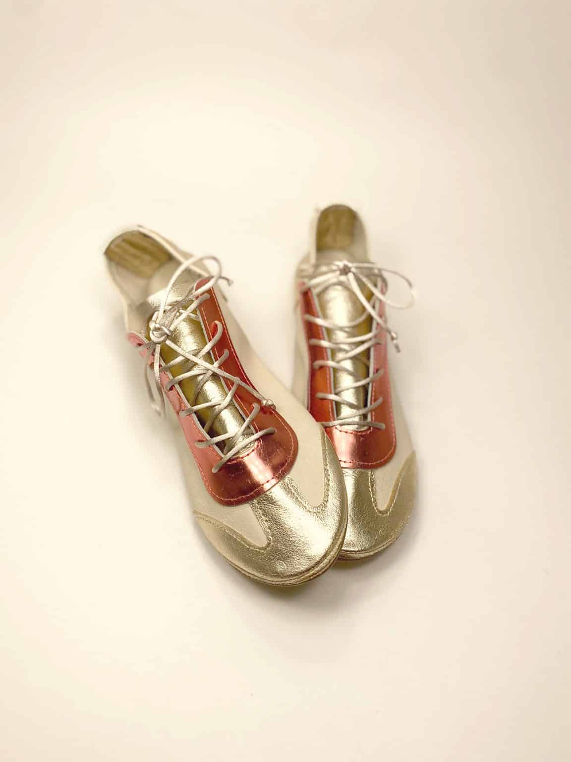 Handmade metallic gold and coral Italian leather trainers overhead angle